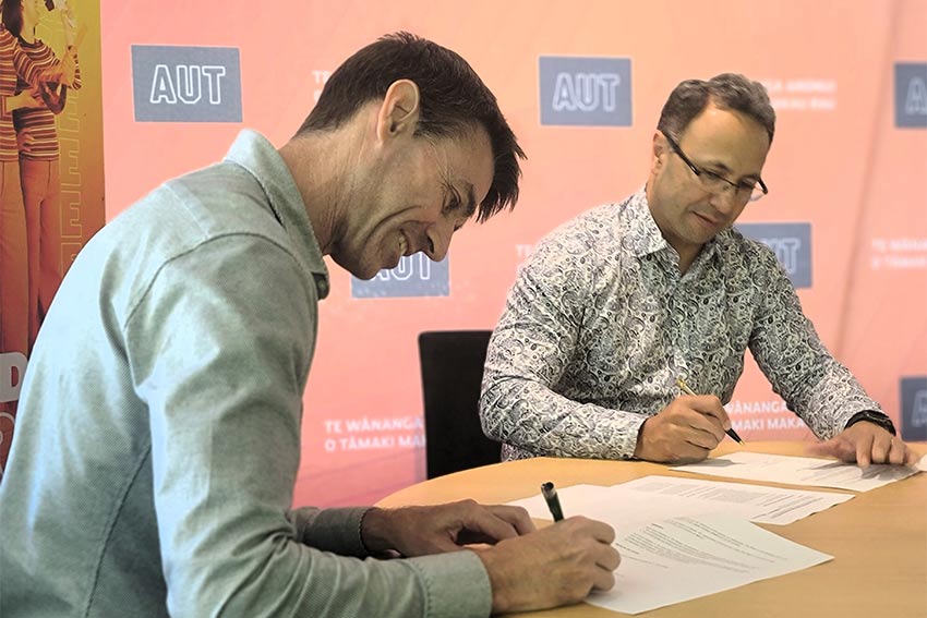 Andrew and Damon signing close up Andrew and Damon signing close up