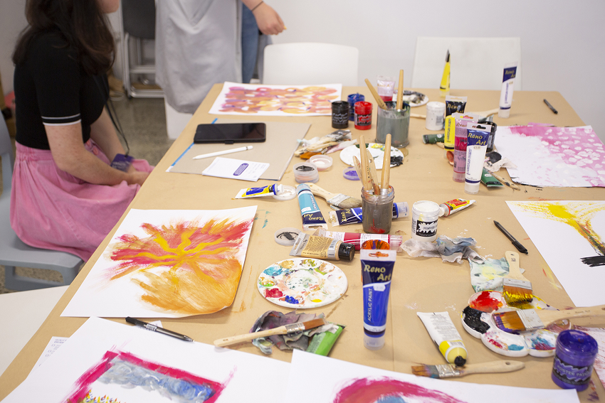 Paints and  brushes on a table