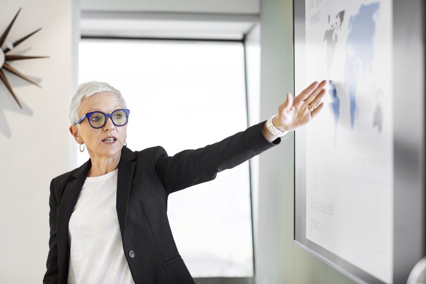 Woman standing in front of a white board