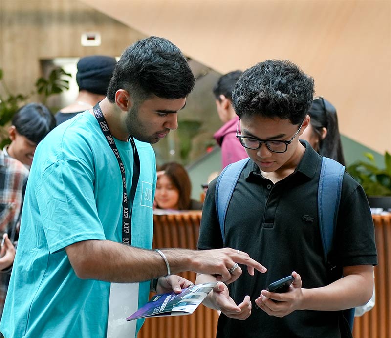 Student ambassador assisting person at AUT