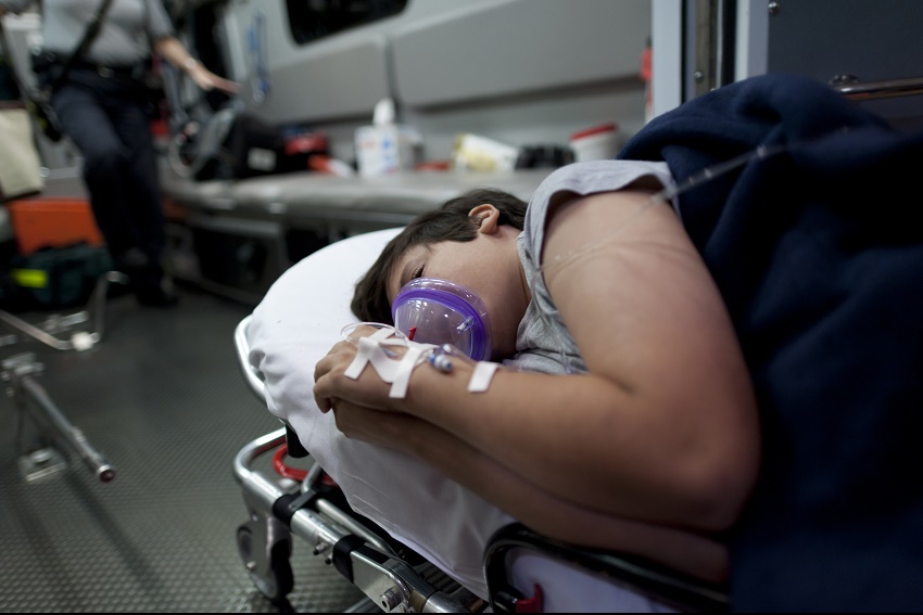 A patient lying down in an ambulance