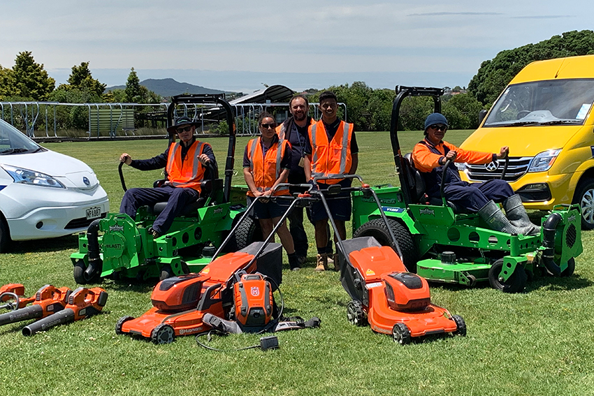 Grounds maintenance staff with electric equipment