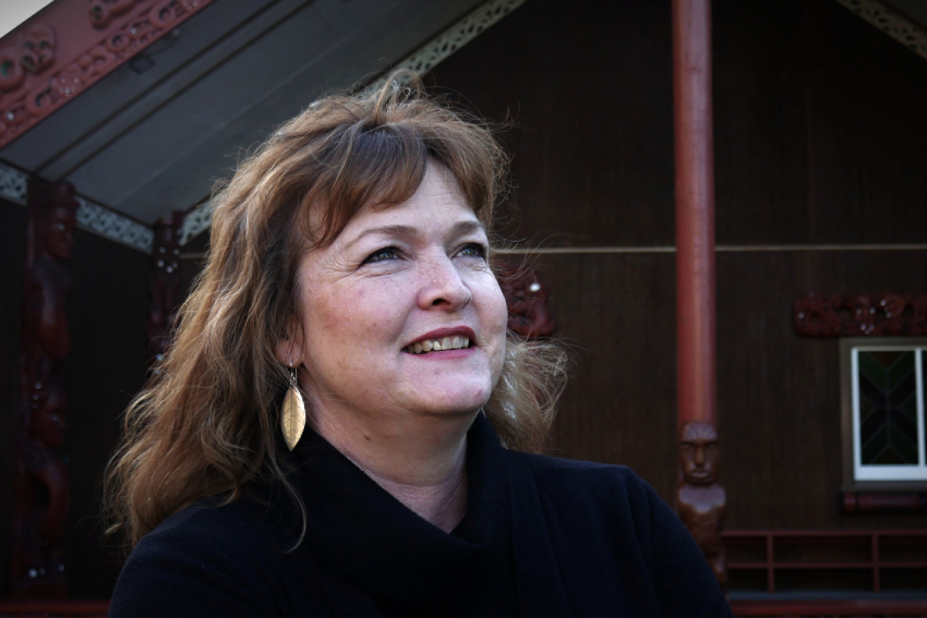 Dr Atakohu Middleton in front of the wharenui at AUT.