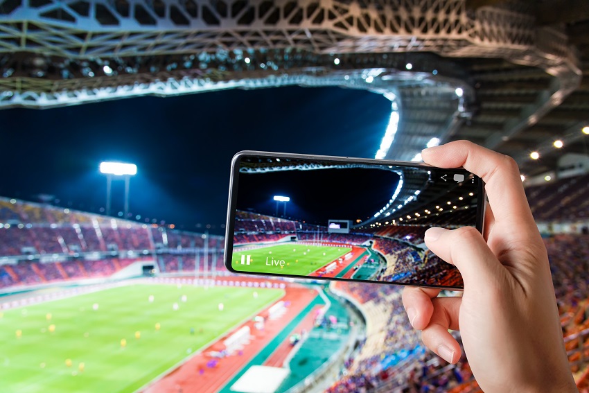A phone recording a sports game in an arena
