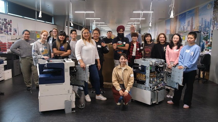 AUT Business students with a dismantled Xerox machine