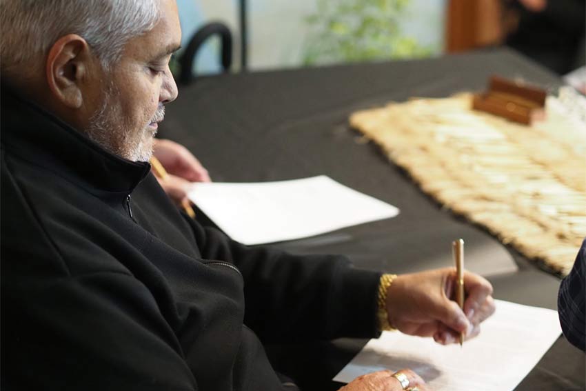 a man signing a document