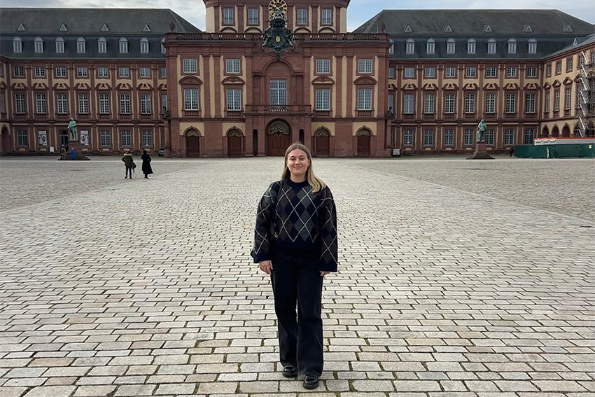 Frankie posing in frotn of a historic building