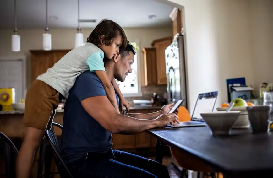 A dad and child juggling work and school holidays