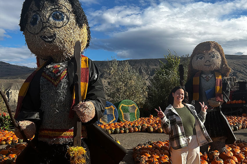 Remy posing with Harry Potter characters made out of Hay
