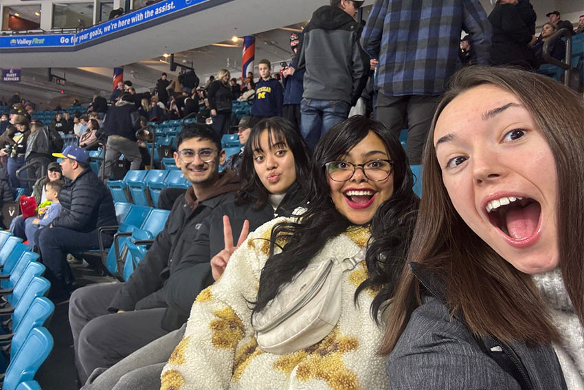 A group taking a selfie at a sports game