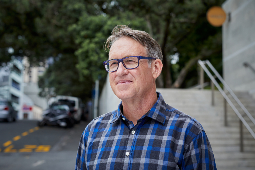 Professor Simnon in a blue checkered shirt.