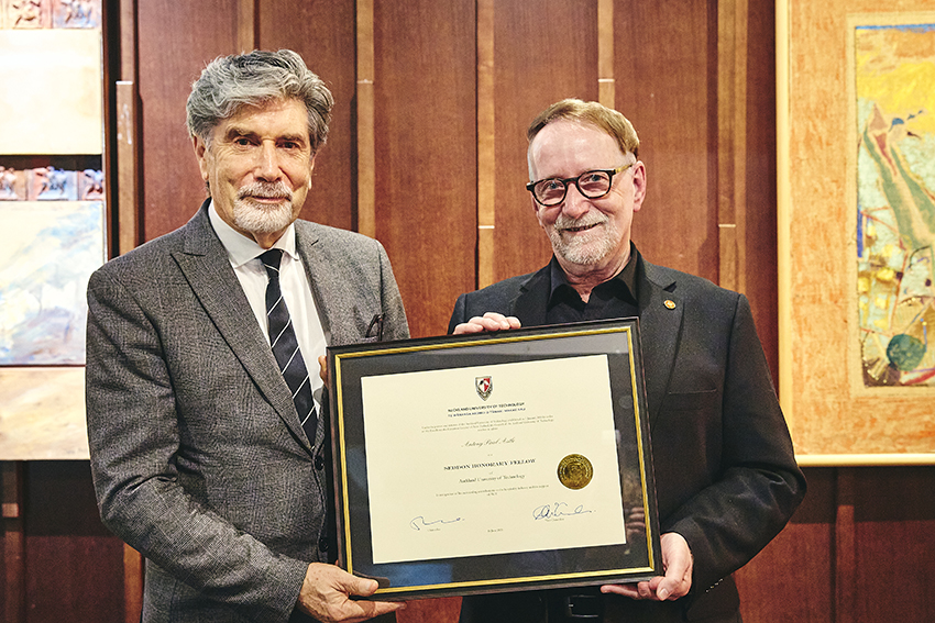 AUT Vice-Chancellor Derek McCormack and restaurateur Tony Astle standing next to each other with a certificate.