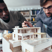 Two architects working on model home