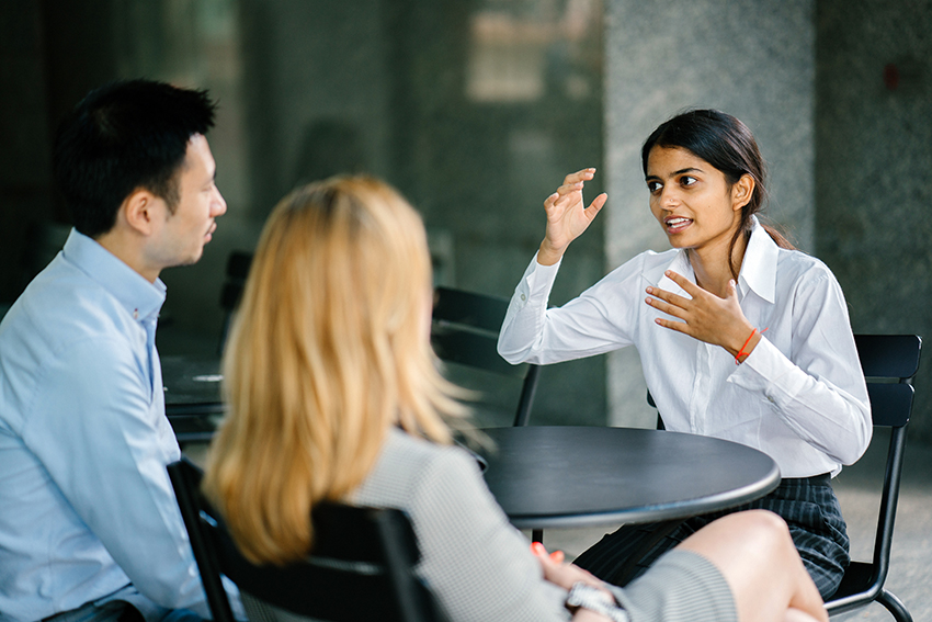 Stock image showing a job interview in a cafe-like setting