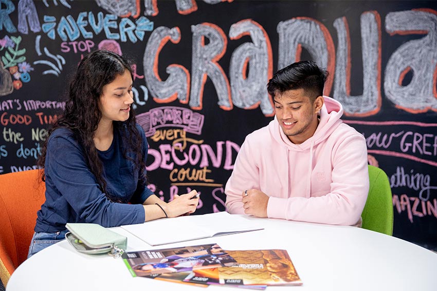 2 students sitting around a table