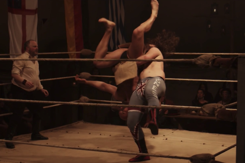 Screenshot of TVNZ's Colonial Combat showing two wrestlers in the ring and referee.