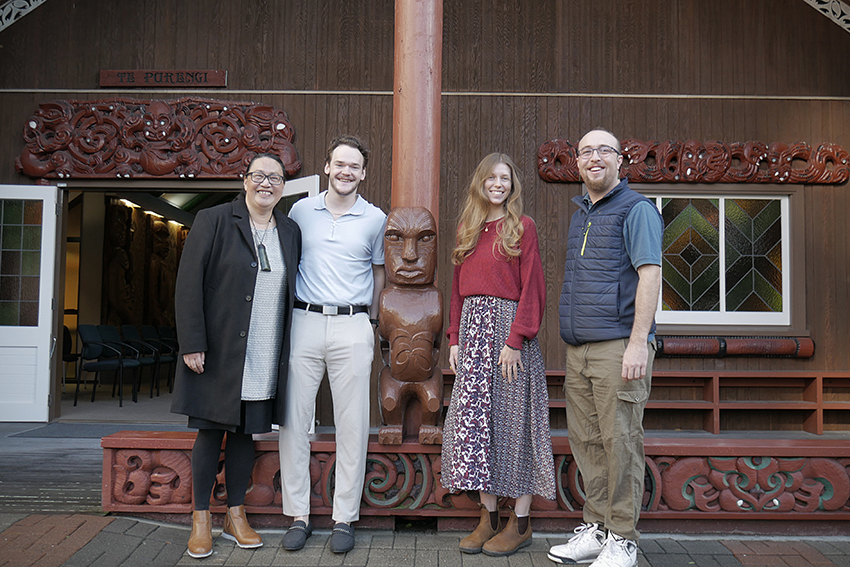 Standing outside AUT's wharenui: From left: Elberta Chan (Student Hub Practice Manager International), international students Blake Wilson and Tess Messingham, and Kaiwhaikōrero Kururangi Johnston. 