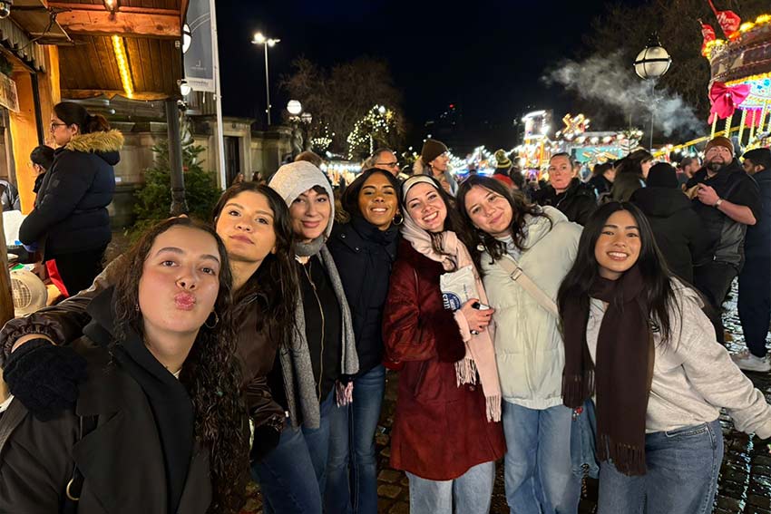 A group of people posing for a photo in a night market