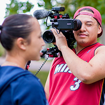 Person holding video camera filming