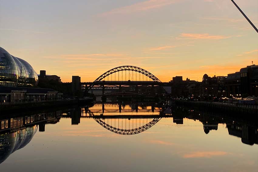 A bridge with the sunset in the background
