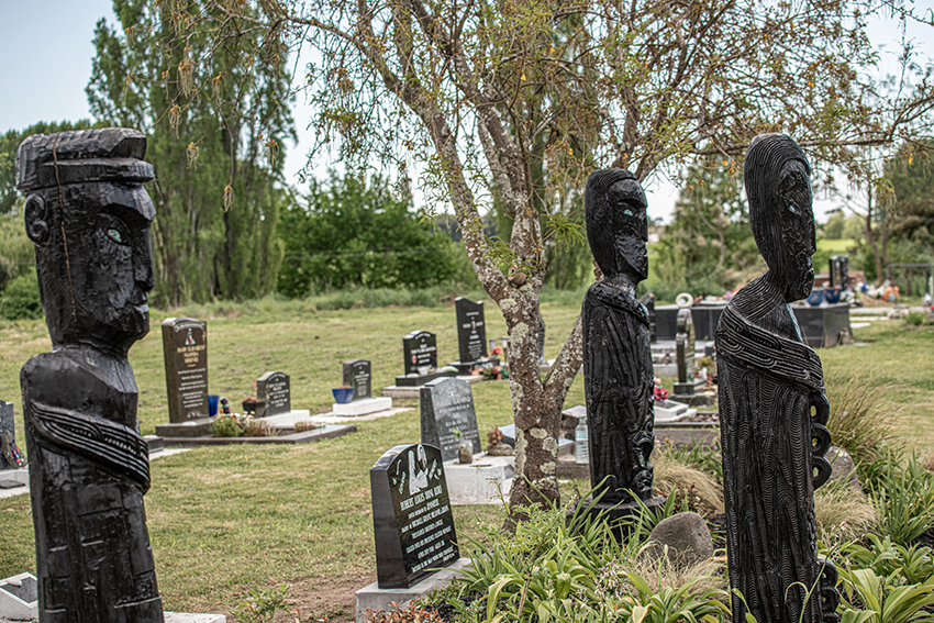 The three black pou at the urupā tautaiao.